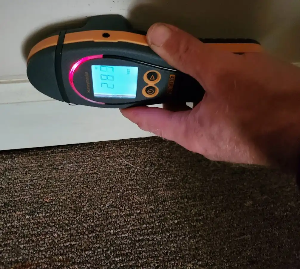 Moisture detection at baseboard during Storm Damage Restoration in Kennedale